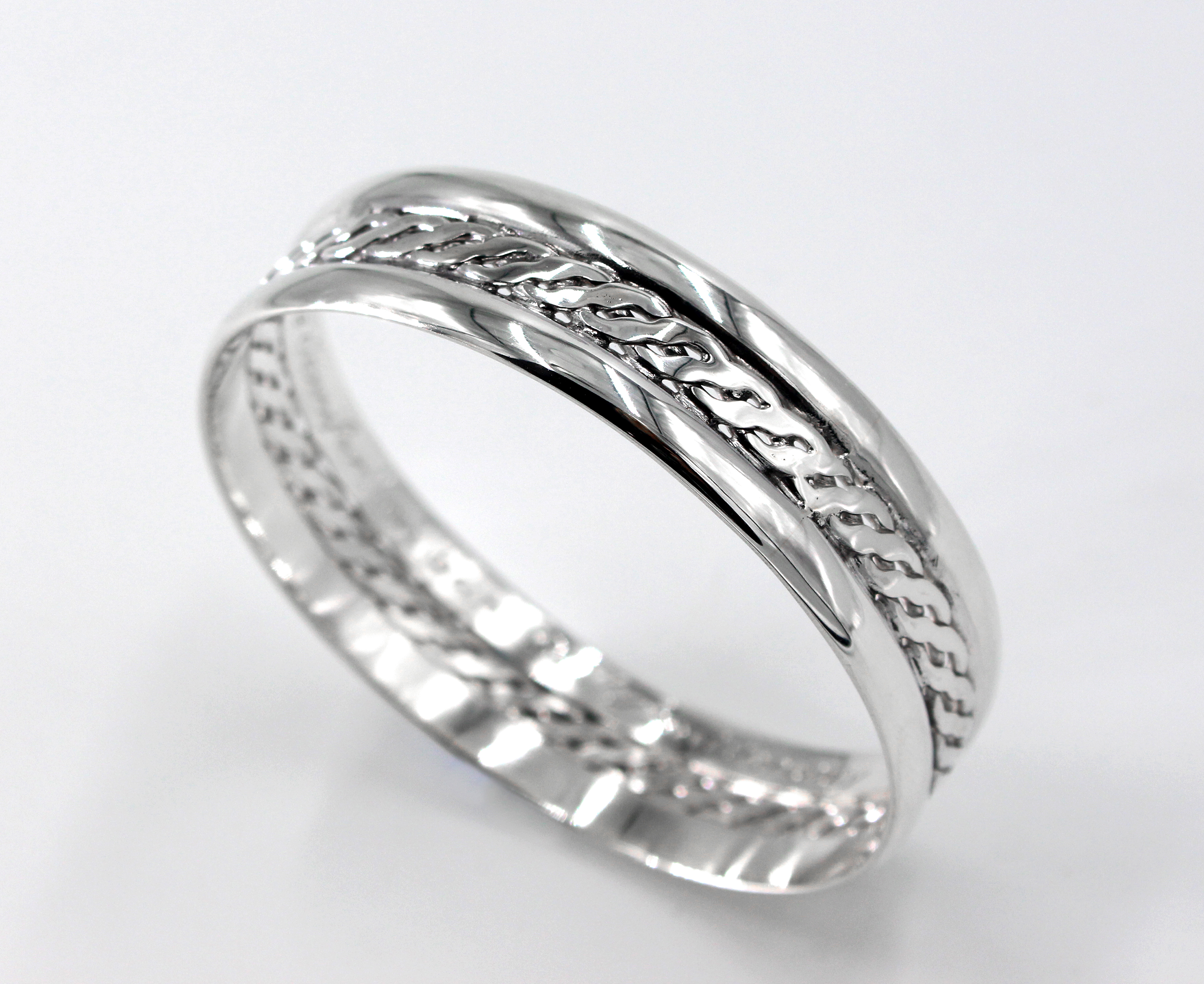 Wide sterling silver bangle with a woven centre and engraved message