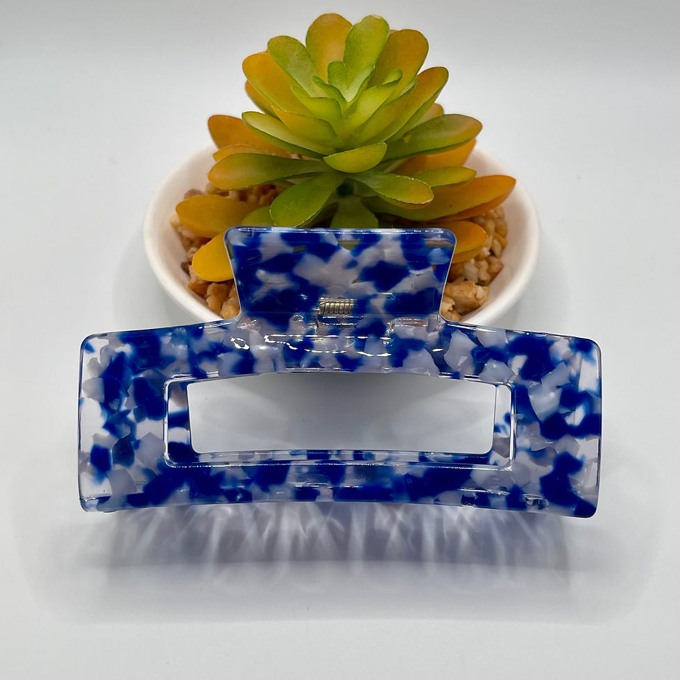 Thumbnail: A royal blue rectangular hair clip with a trendy graphic design, featuring a sturdy claw clip for a secure hold and effortles