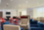 Hotel dining area with tables, chairs and TV