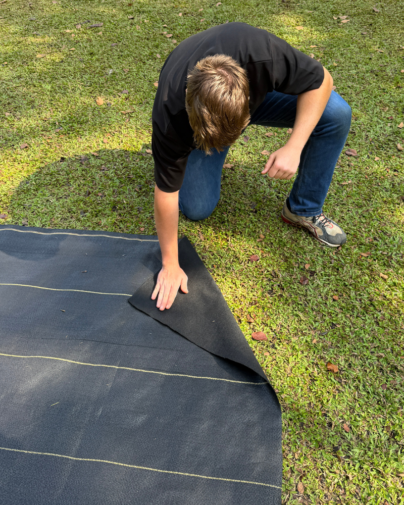 DOTDAY heavy-duty woven landscape fabric being installed in a garden - weed barrier USA