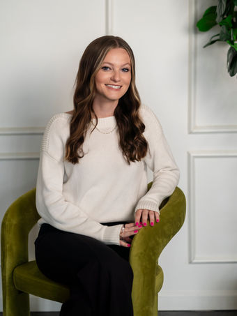 Kelli Humphrey, speech-language pathologist at Insight Speech and Swallowing Therapy, seated in an olive green armchair.