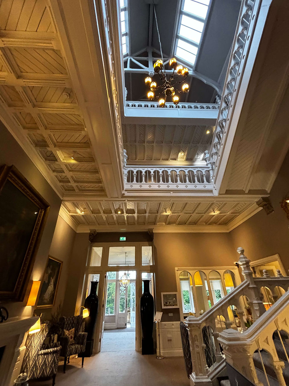 Construction site in Essex showing installation of sustainable drainage system with excavated swale and attenuation basin visible, construction dust management measures including water suppression equipment operational, site compound with IAQM-compliant dust monitoring, temporary drainage protecting neighbouring properties from surface water run-off during building works, demonstrating responsible construction practices for BREEAM credits