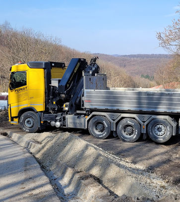 gelber LKW mit grauer Ladefläche