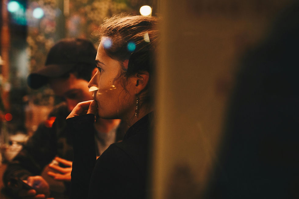 A thoughtful woman in a busy background