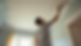 High angle view of a painter applying fresh paint to a ceiling