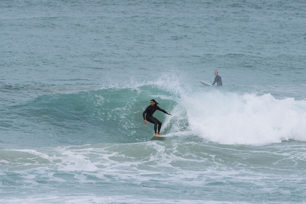 Surfer riding a wave on the Atlantic coast near Mirleft, Morocco.