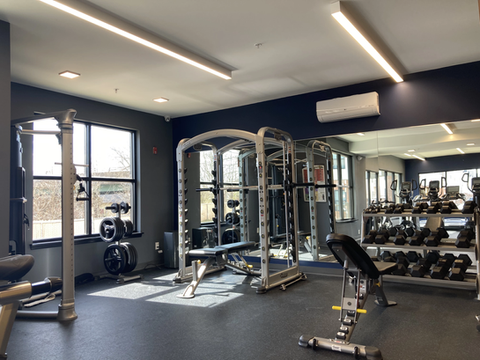 Weight lifting station with benches and free weights. Apartments on University of Delaware Campus.