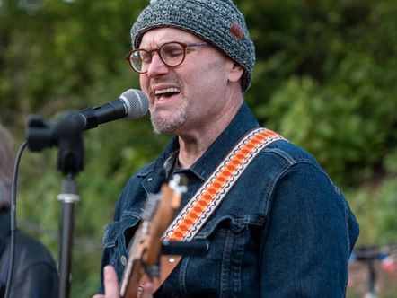 Lead guitarist Glenn Thrush of Running Late, a band, performing on an outdoor stage at Baby Cat Brewery, Kensington, MD, Spring 2025