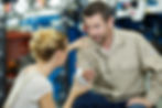 a woman helping a man with an arm injury