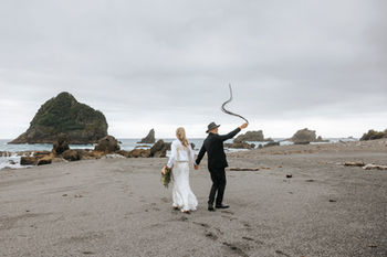 Adventure wedding couple enjoying the West Coast beach NZ