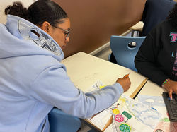 Student working on artwork for exhibit