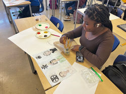 Student working on artwork for exhibit