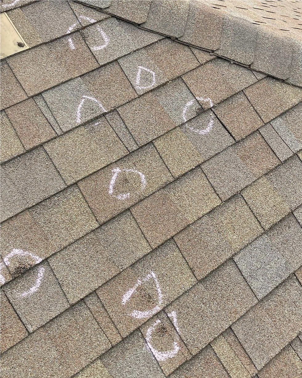Hail damage on asphalt shingles.