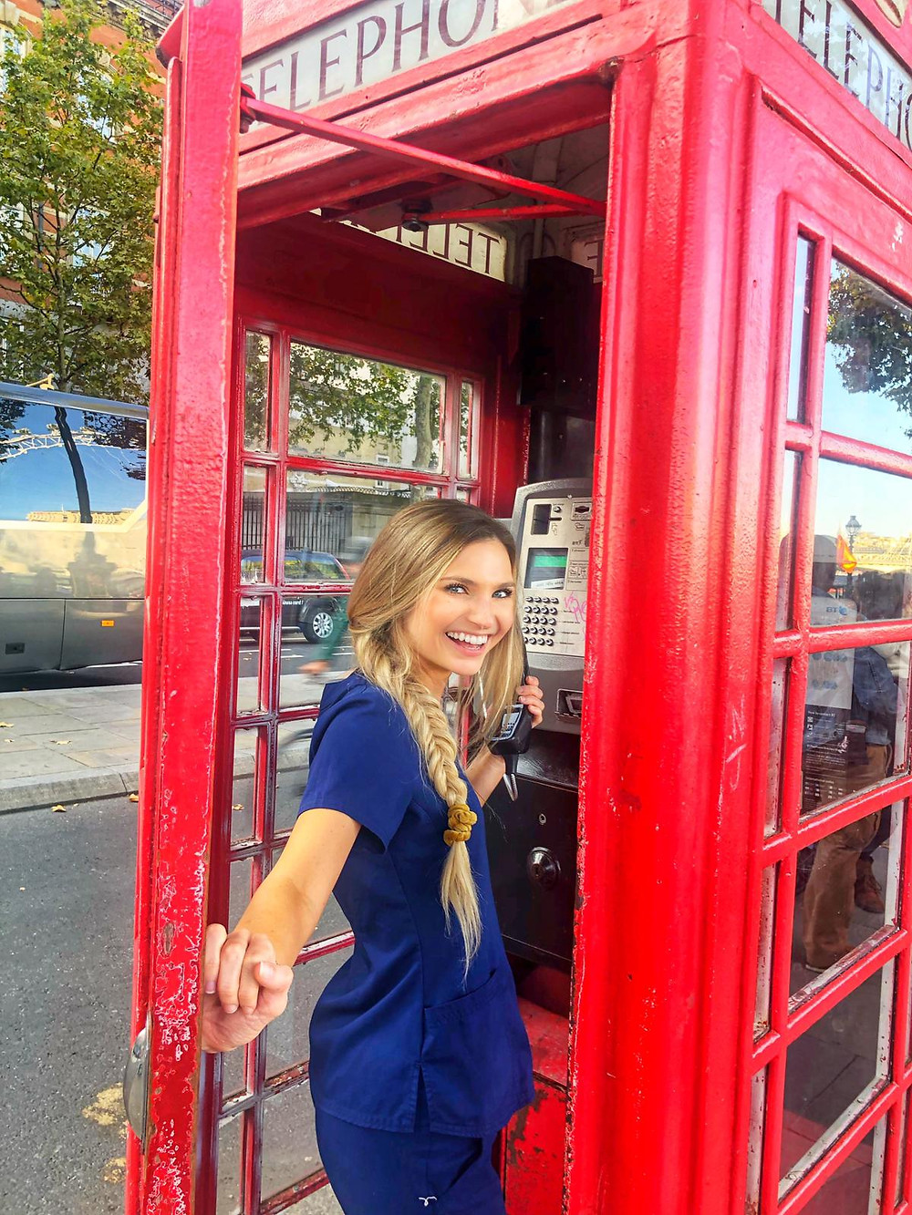 travel nurse and lifestyle blogger kirsten conrad in a phone box