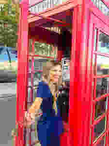 travel nurse and lifestyle blogger kirsten conrad in a phone box