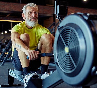 senior on rowing machine