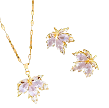 Bordeaux Leaf jewellery options showing a gold-tone leaf necklace, earrings and pendant with burgundy stone detailing