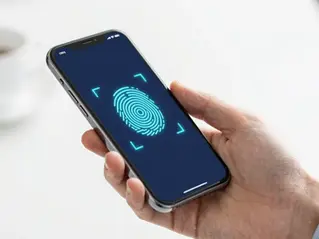 A person unlocking a banking app with facial recognition while a holographic HUD shows a real-time risk score, in WAU's visual style.
