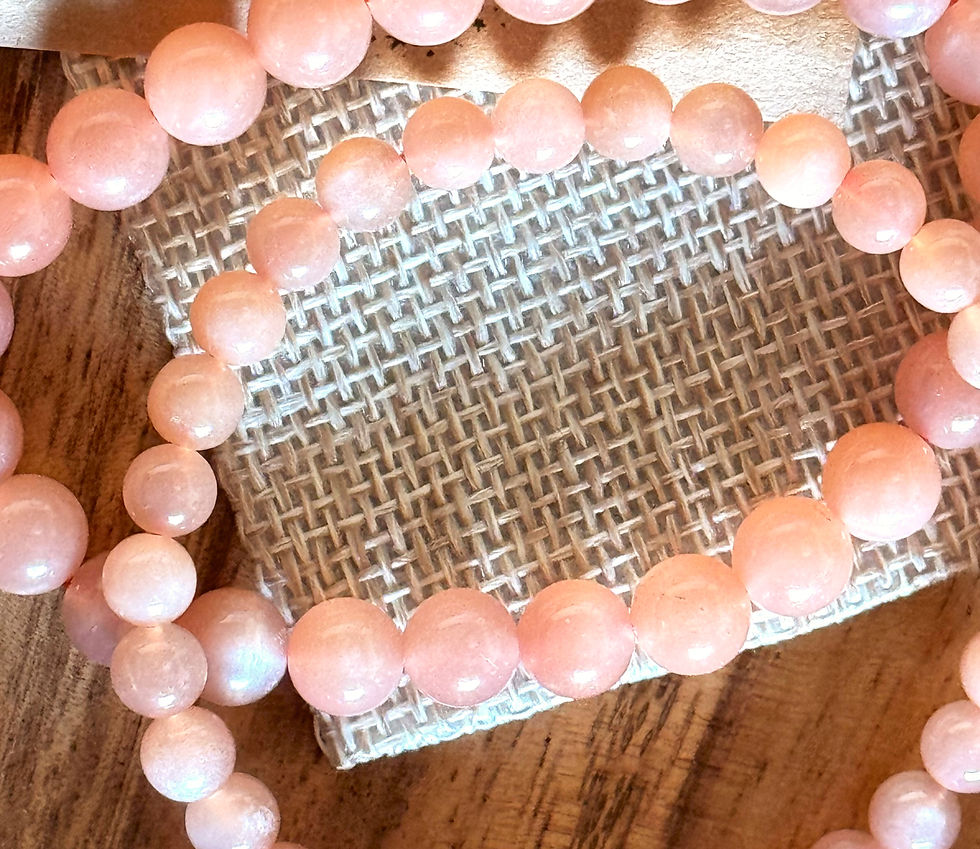 Eye-level view of a sunstone bracelet displayed on a wooden surface