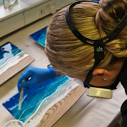 Carefully creating a resin ocean placing white pigment
