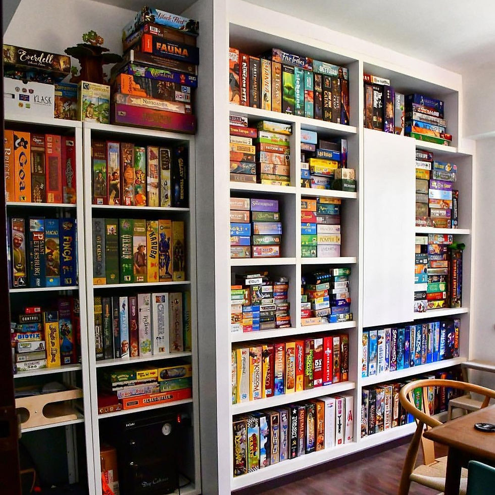 The sign of a true board gamer, a wallful of of shelves stacked with board games