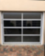 New modern glass panel garage door installed on a home in Baldwin County Alabama