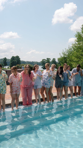 Bride and bridesmaids enjoying a cocktail by the pool before getting ready for the wedding ceremony at Brittland Manor