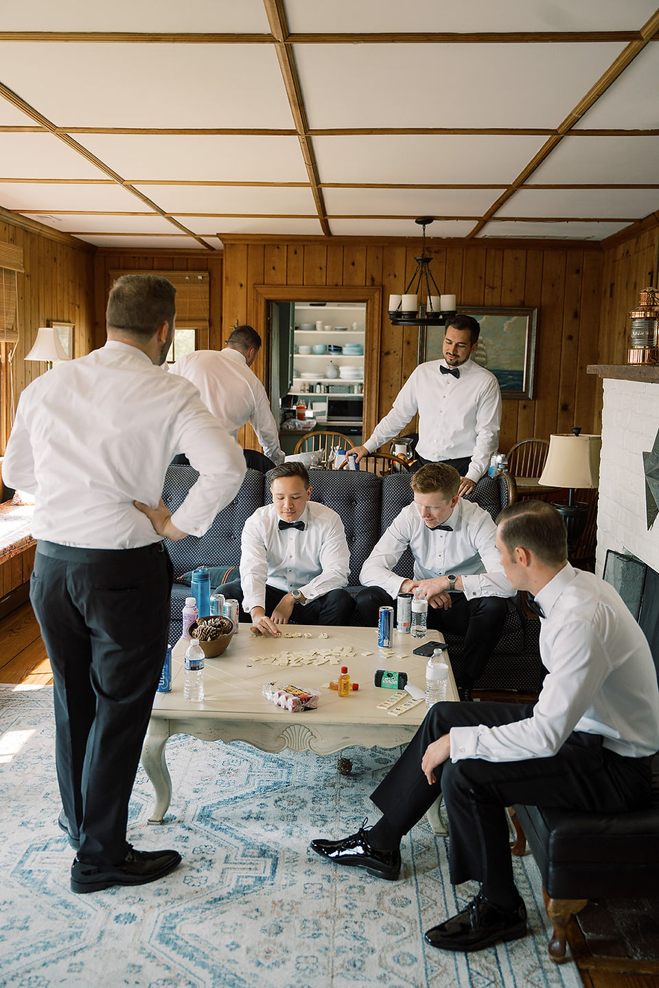 Groom and groomsmen playing cards in the River Lodge before the wedding cceremony