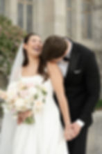groom kissing bride on shoulder