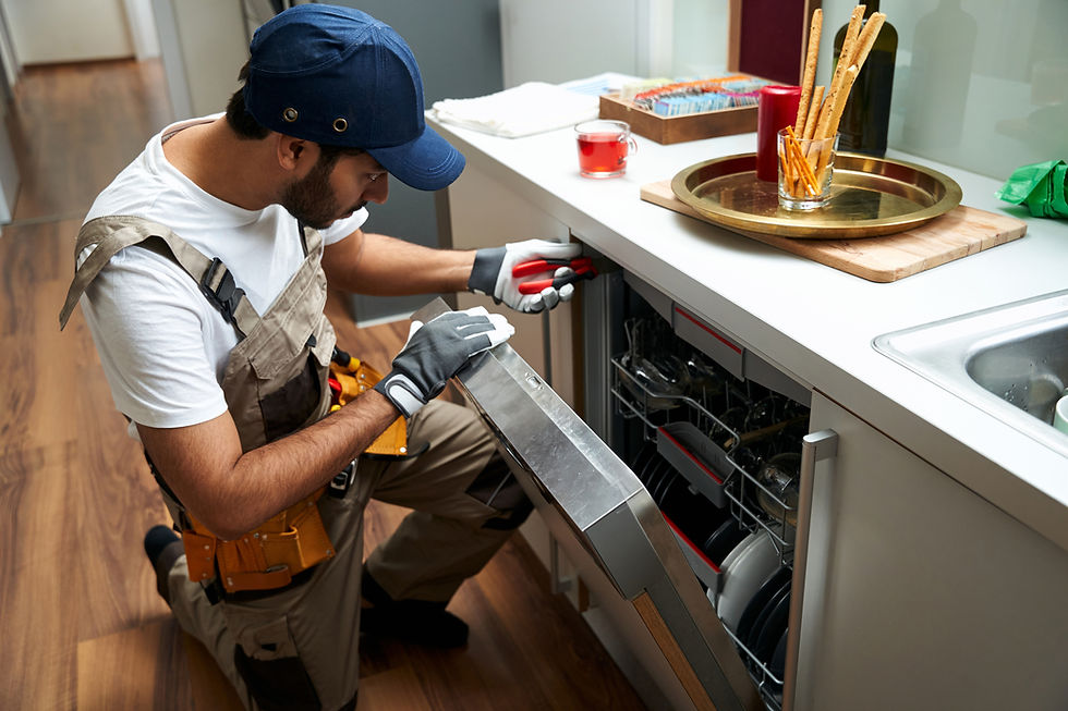 young-repairman-service-worker-repairing-dishwasher-appliance-kitchen-while-use-special-to