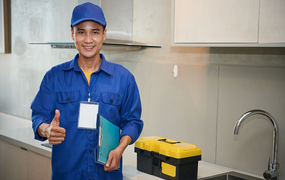 cheerful-asian-plumber-standing-near-kitchen-sink-showing-thumb-up.jpg