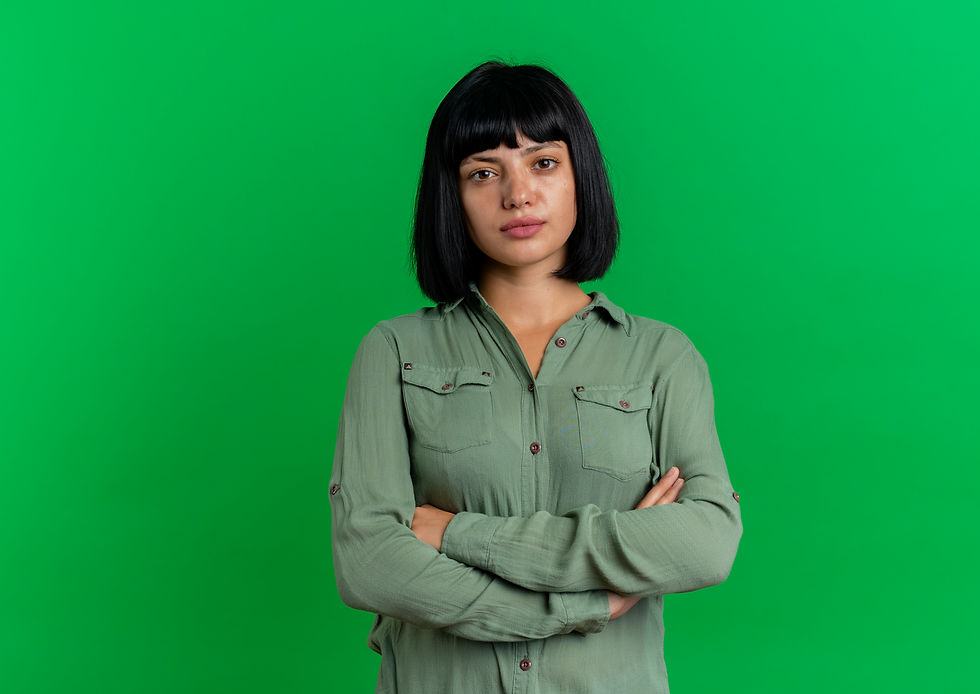 confident-young-brunette-caucasian-girl-stands-with-crossed-arms-isolated-green-background