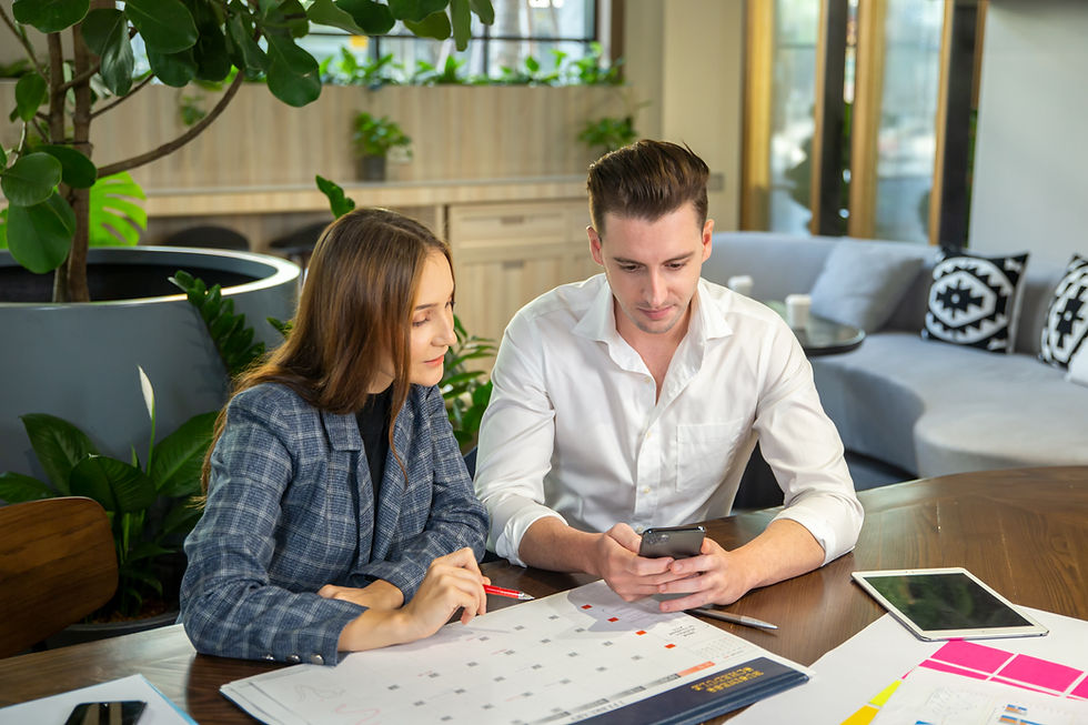 young-couple-looking-camera-while-sitting-table.jpg