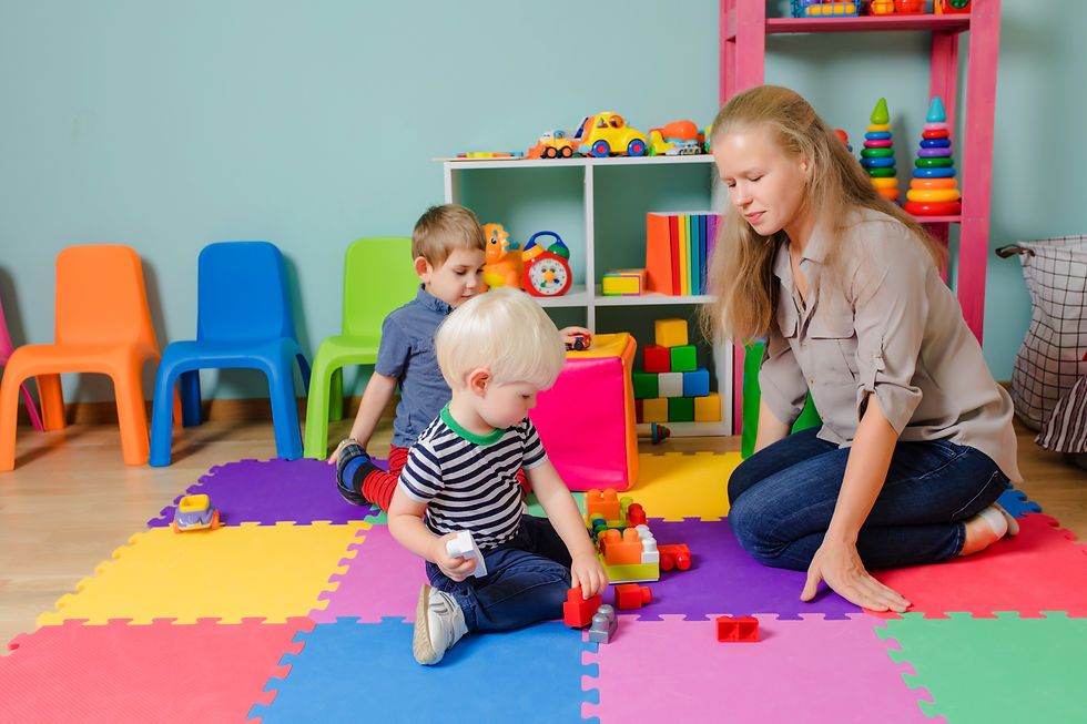 teacher-with-kids-are-sitting-floor-playing-boy-play-with-construction-blocks.jpg