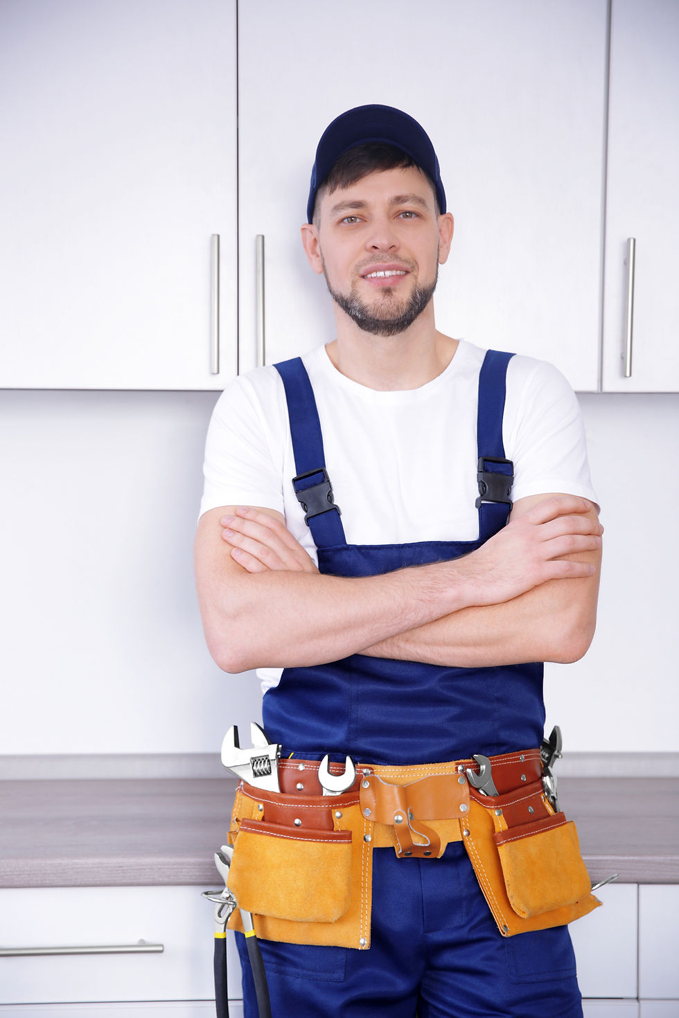 plumber-with-crossed-arms-standing-kitchen.jpg