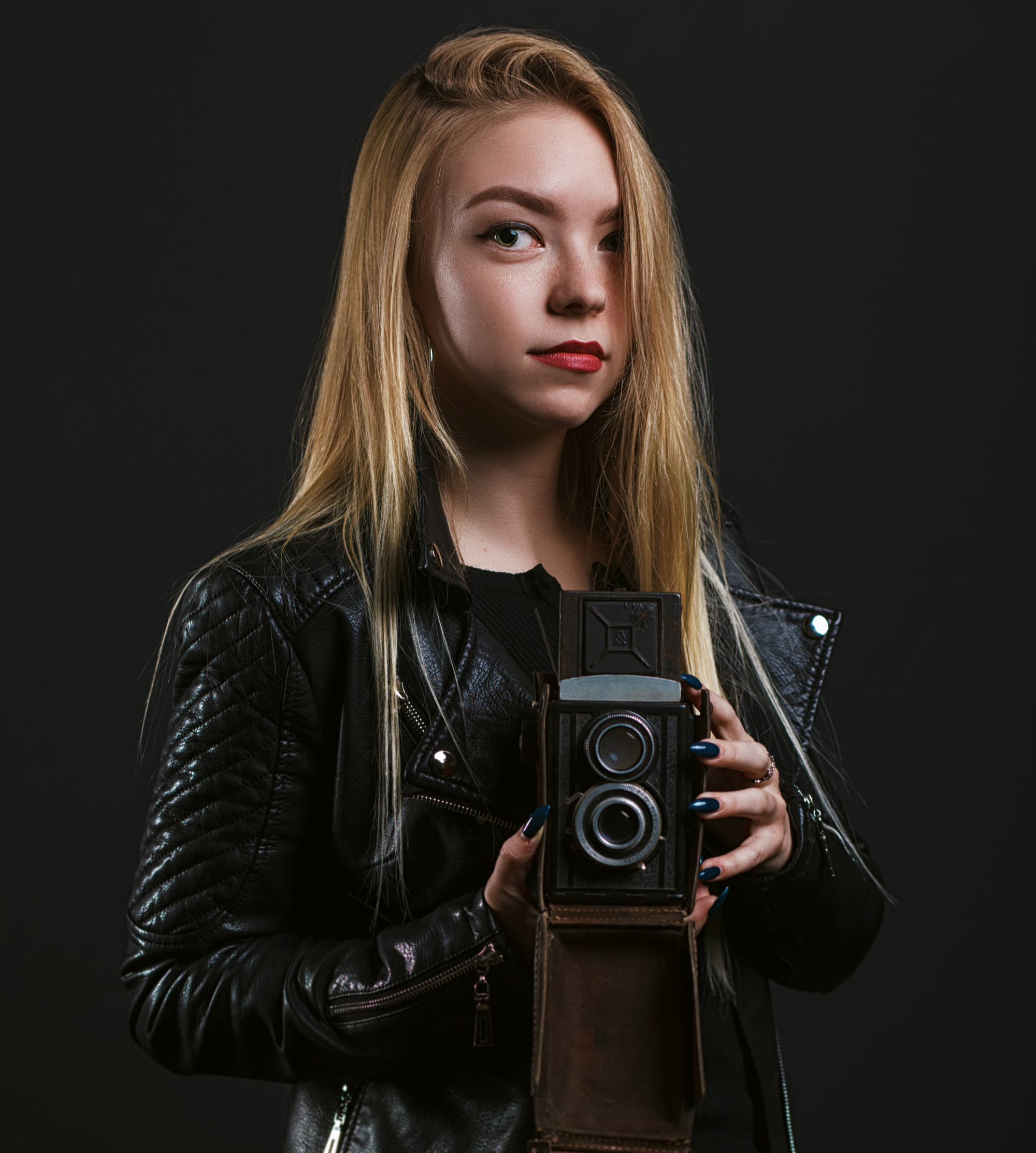 stylish-hipster-girl-wears-black-leather-jacket-holding-old-vintage-photo-camera-black-bac