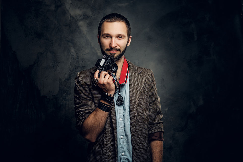 attractive-pensive-man-with-photo-camera-is-posing-photographer-dark-photo-studio.jpg