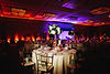 decorated-banquet-hall-with-served-round-table-with-hydrangea-centerpiece-chiavari-chairs.