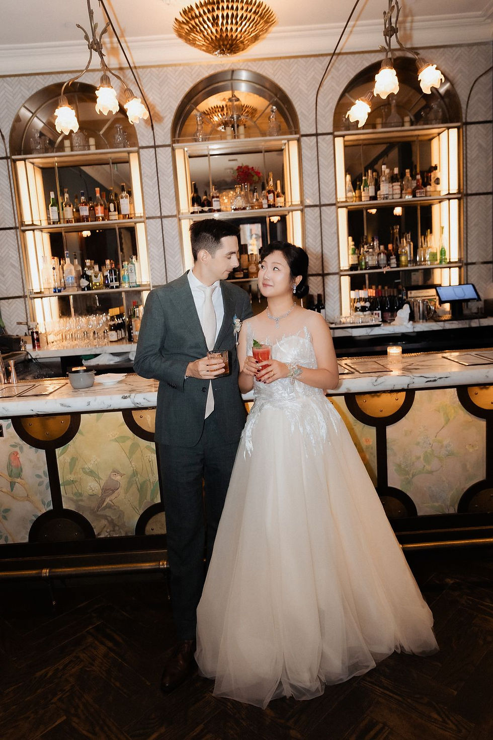 The couple at the bar at Maison Selby during their wedding dinner.