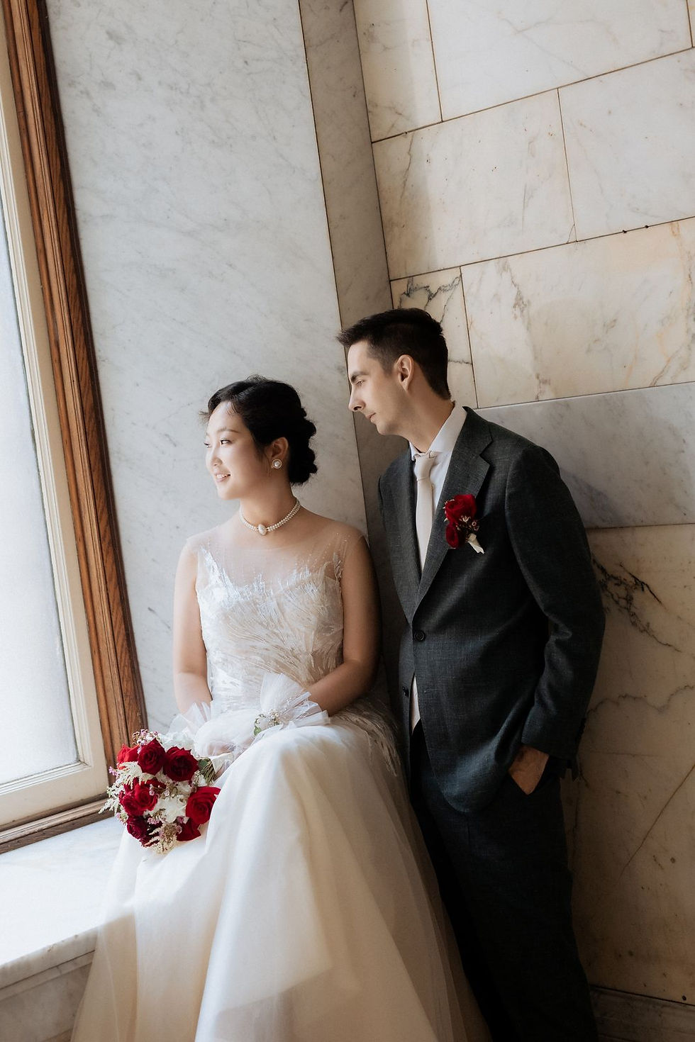 Portrait of the couple at a window inside Old City Hall in Toronto.
