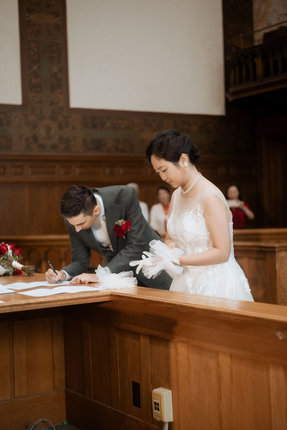 Signing the marriage register at the table in the former Council Chamber at Old City Hall in Toronto.