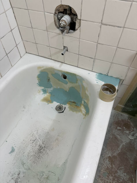 Why is it advisable to remove hardware such as the faucet, drain, and shower doors before refinishing?