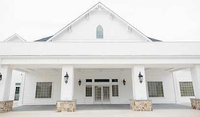 Photo of outside the venue on location. White building.
