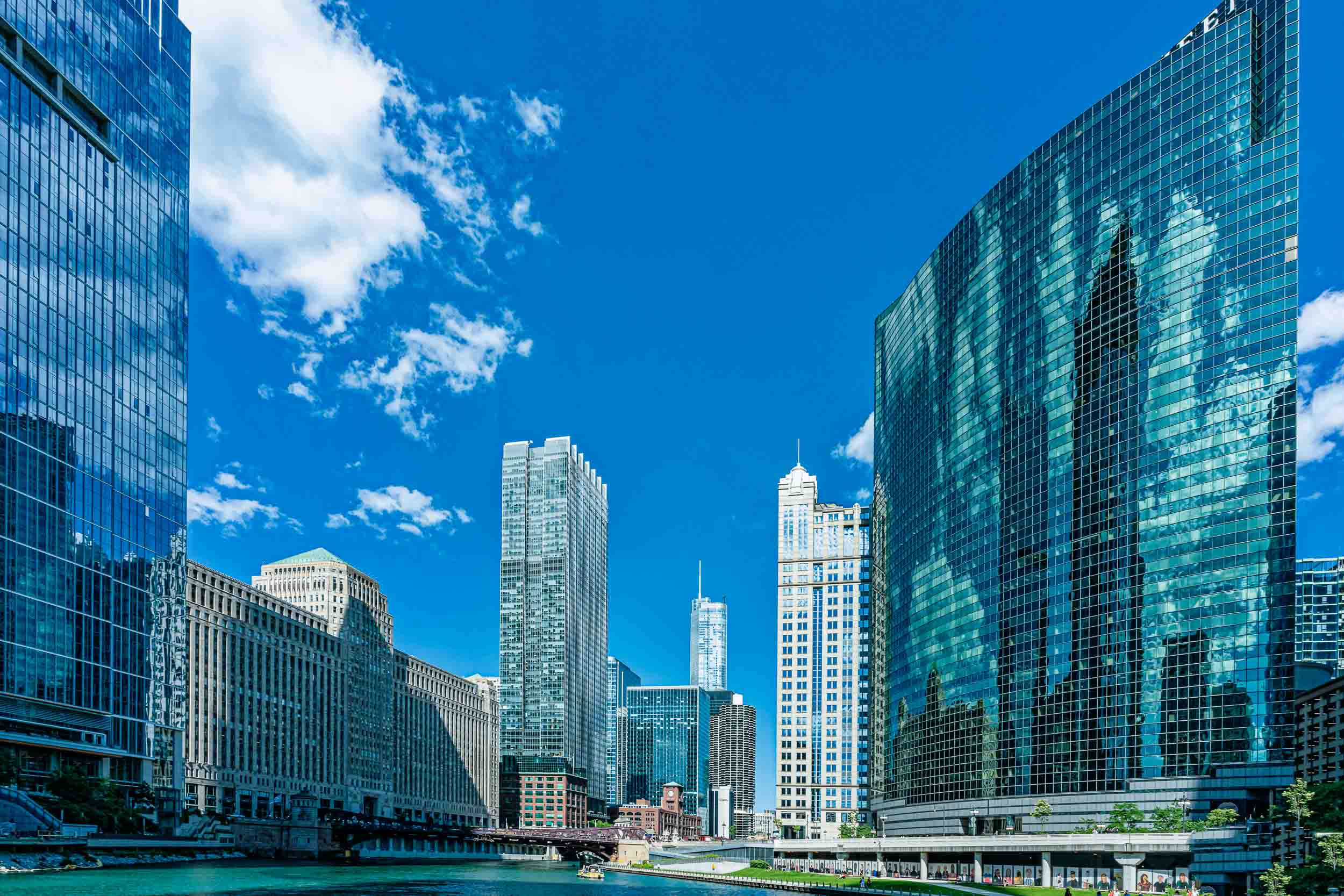 Chicago sky scrapers captured with the river and blue sky with white clouds.
