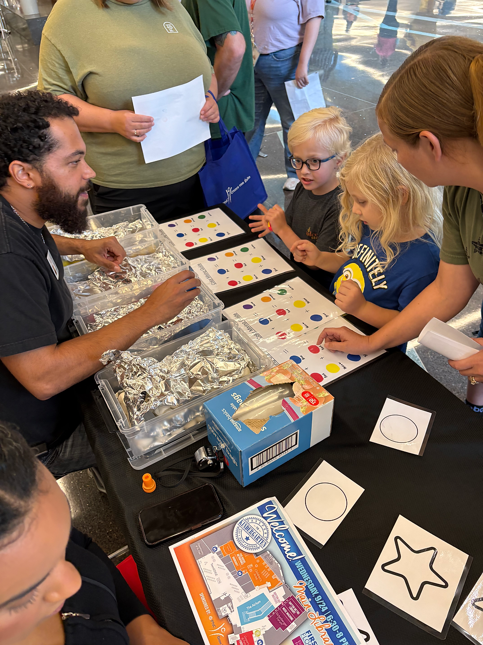 Children working on mixing colors at PLC event