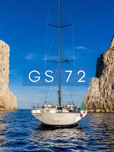 GS 72 sailing yacht between dramatic cliffs