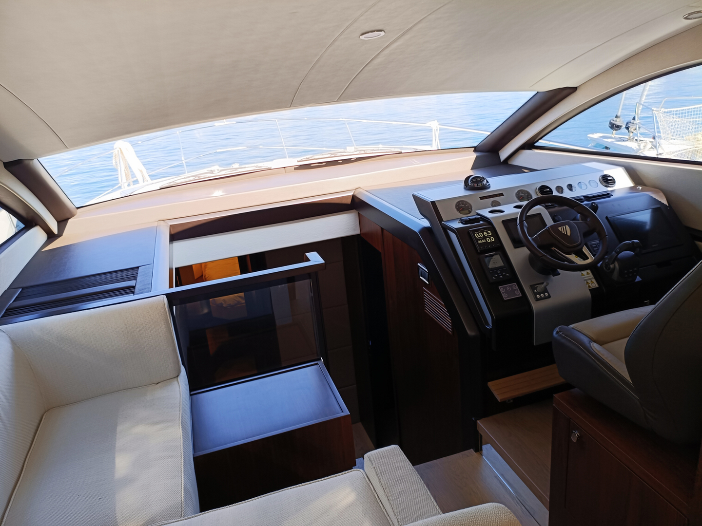 Luxury yacht interior: helm, seating, ocean view