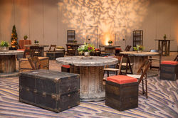 Trunks set around wood spool as seating area