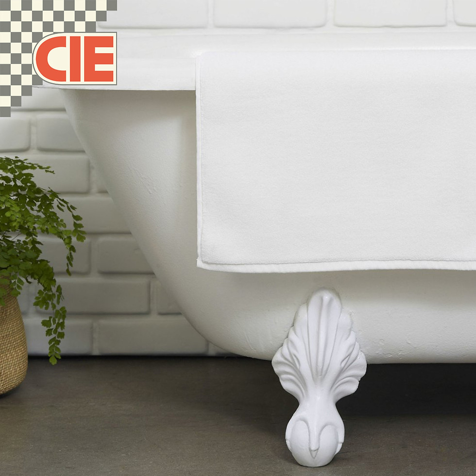 Thumbnail: "Elegant white bath mat" – "Crisp white hotel bath mat with a stylish border design, adding a touch of elegance to the bathroom décor."