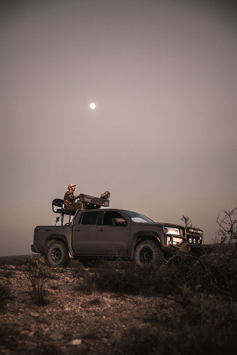 hunter in truck at dusk